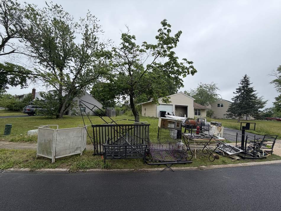 Curbside pile of furniture and scrap metal waiting for pickup
