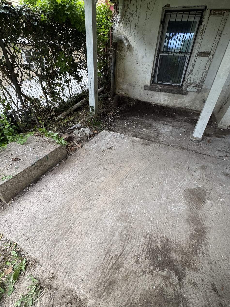 Porch cleared down to clean concrete after debris removal